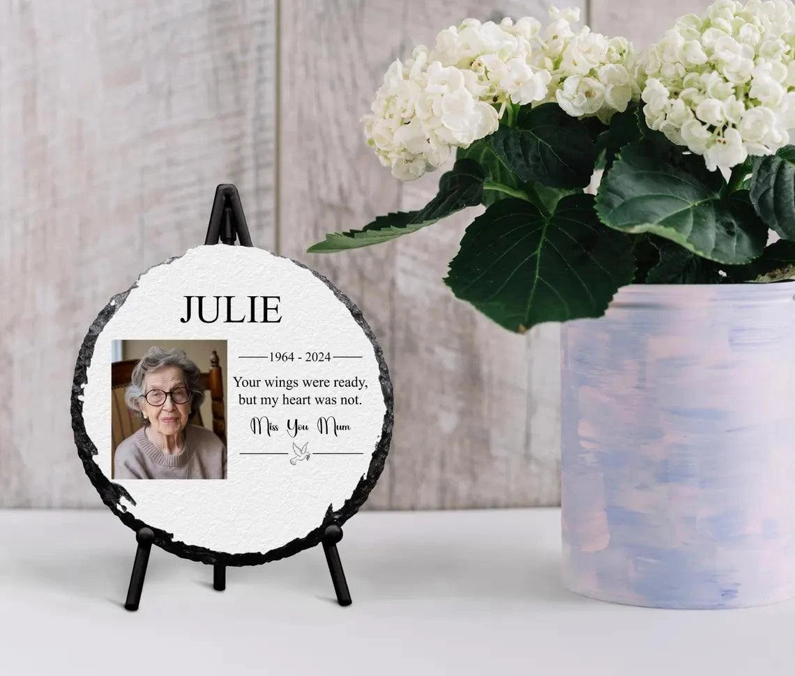 Round personalised memorial slate with photo, glossy finish, and black stand, ideal for tribute keepsake display.